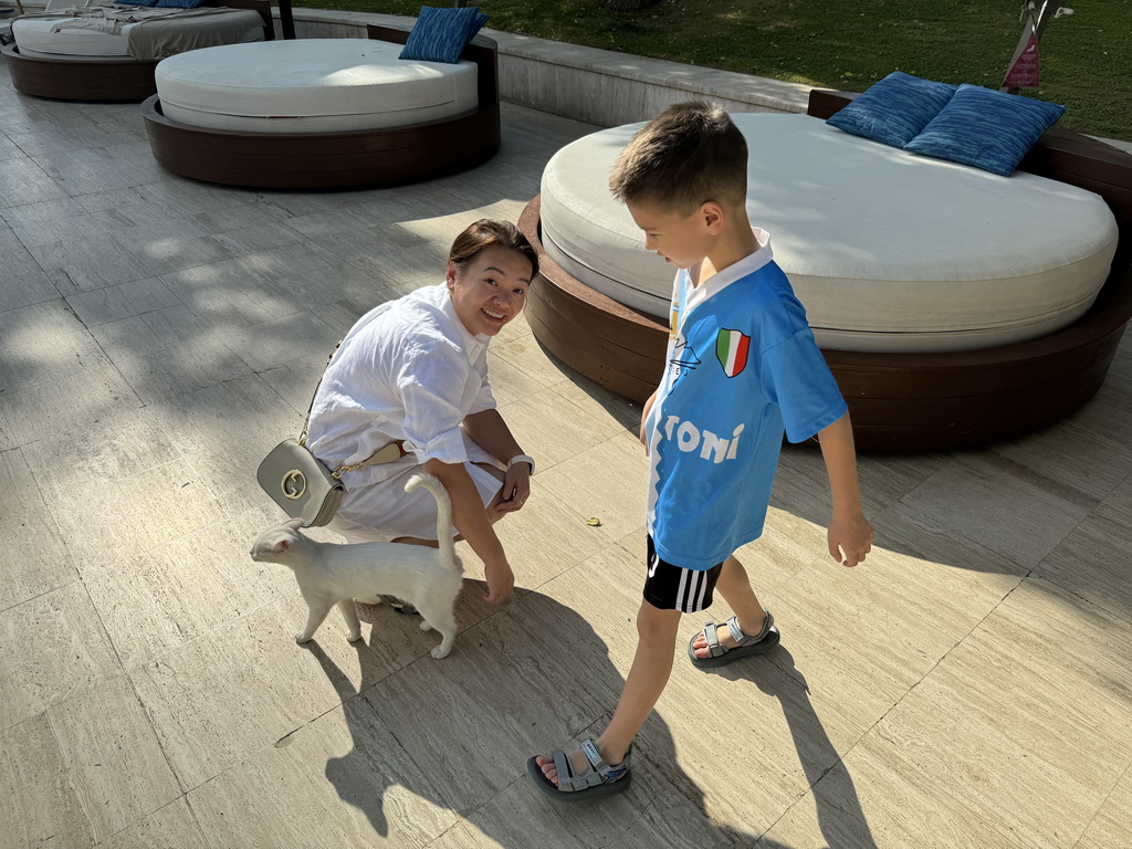 Miaomiao and Max with a cat at the garden of the Rixos Downtown Antalya hotel