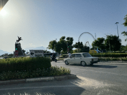 The Mustafa Kemal Ataturk Aniti monument and the Ferris wheel at the Aktur Park, viewed from the taxi at the Dumlupinar Boulevard