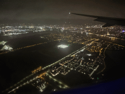 The west side of the city of Antwerp with the Scheldt river, the Cathedral of Our Lady and a ferris wheel, viewed from the airplane to Antwerp, by night