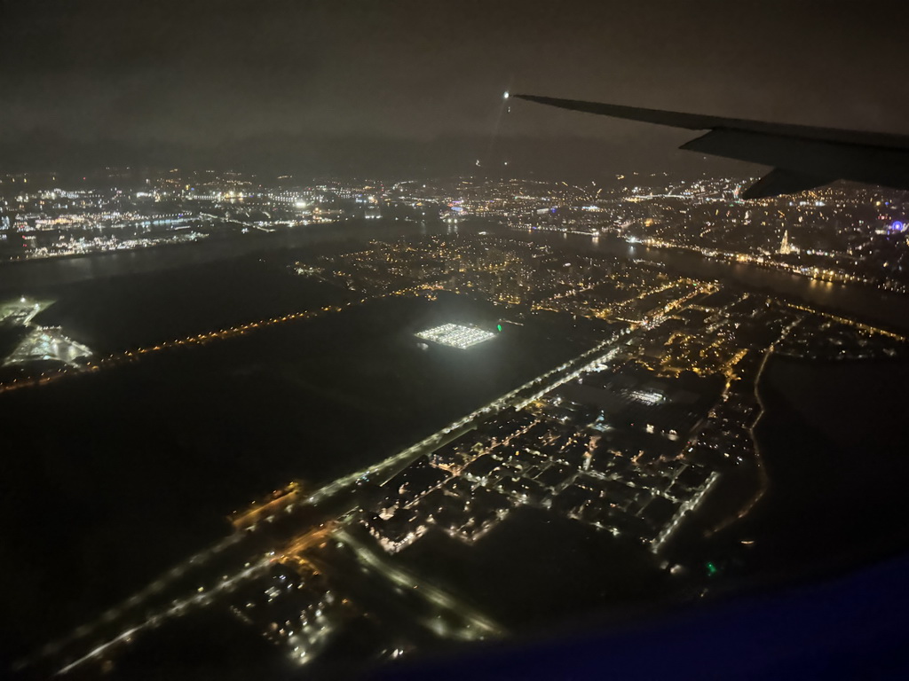 The west side of the city of Antwerp with the Scheldt river, the Cathedral of Our Lady and a ferris wheel, viewed from the airplane to Antwerp, by night