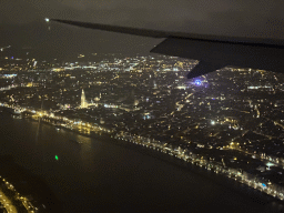 The city center of Antwerp with the Scheldt river, the Cathedral of Our Lady and a ferris wheel, viewed from the airplane to Antwerp, by night