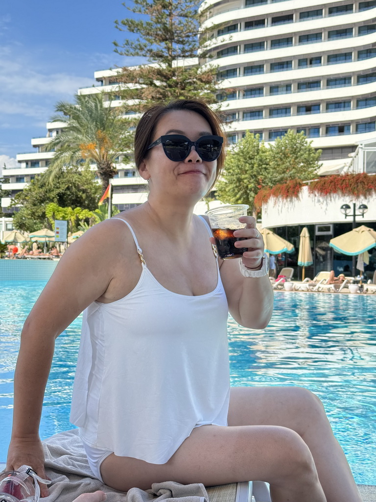 Miaomiao with a drink at the swimming pool at the garden of the Rixos Downtown Antalya hotel