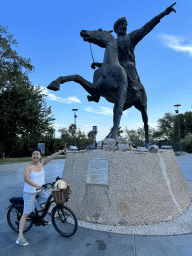 Miaomiao on her bicycle at the equestrian statue of Sultan Giyaseddin Keyhüsrev I at the Republic Square, with explanation