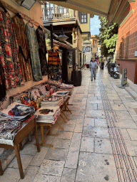 Clothes and tapestries in front of a shop at the Kocatepe Sokak alley