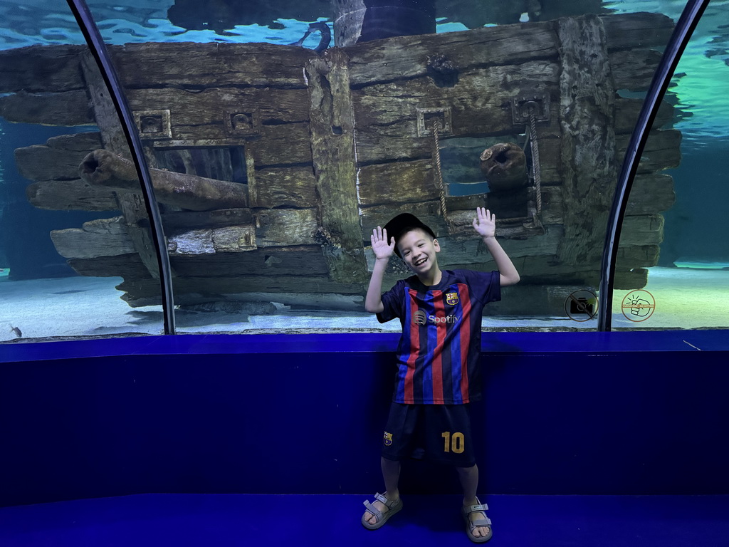 Max with the ship wreck at the Pirate Treasures section of the World`s Biggest Tunnel Aquarium at the Ground Floor of the Aquarium at the Antalya Aquarium