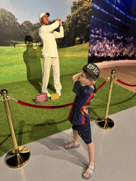Max with a statue of Tiger Woods at the Face 2 Face Wax Museum at the Antalya Aquarium, with explanation