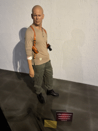 Statue of Bruce Willis at the Face 2 Face Wax Museum at the Antalya Aquarium, with explanation