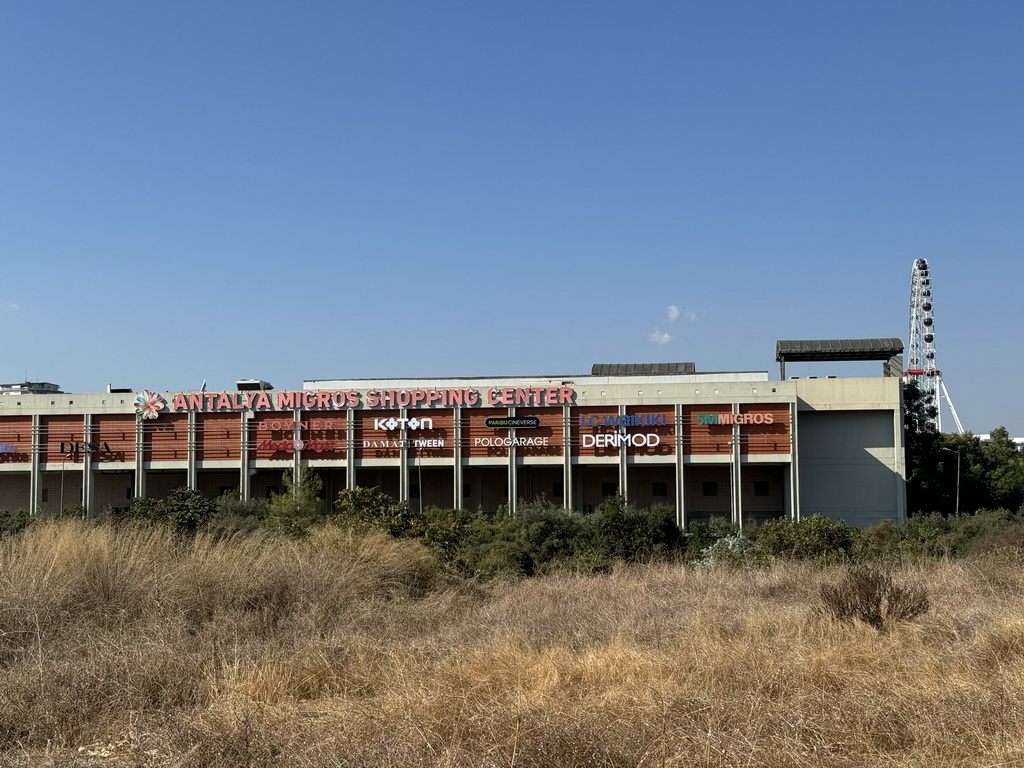 Front of the Antalya Migros Shopping Center at the Dumlupinar Boulevard, with a view on the ferris wheel at the Aktur Park