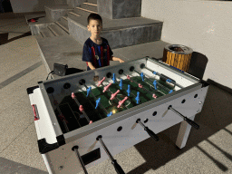 Max playing table football at the sports fields at the garden of the Rixos Downtown Antalya hotel, by night