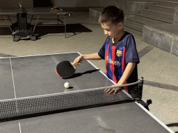 Max playing table tennis at the sports fields at the garden of the Rixos Downtown Antalya hotel, by night