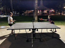 Miaomiao and Max playing table tennis at the sports fields at the garden of the Rixos Downtown Antalya hotel, by night