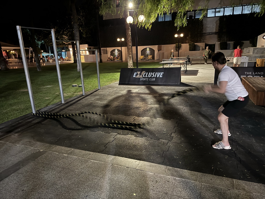 Miaomiao doing fitness at the sports fields at the garden of the Rixos Downtown Antalya hotel, by night