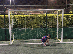 Max playing football at the sports fields at the garden of the Rixos Downtown Antalya hotel, by night