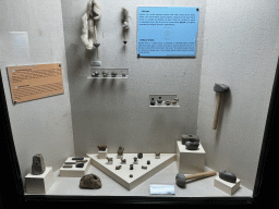 Loom weights, spindle whorl and other tools at the Nature History and Prehistory Gallery at the ground floor of the Antalya Archeology Museum, with explanation