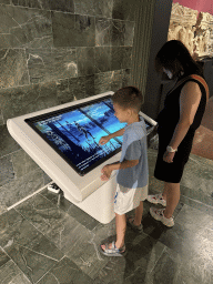 Miaomiao and Max playing a game on a screen at the Perge Theater Gallery at the ground floor of the Antalya Archeology Museum