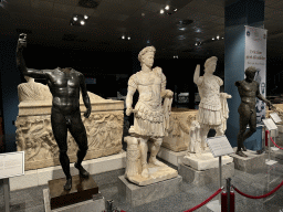 Statues and sarcophagi at the Hall of the Cult of the Dead at the ground floor of the Antalya Archeology Museum, with explanation