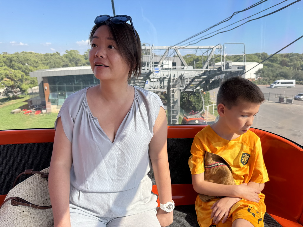 Miaomiao and Max at the Tünektepe Teleferik Tesisleri cable car, with a view on the lower station at the Antalya Kemer Yolu road