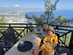 Miaomiao and Max at the terrace of the bar at the Tünektepe Teleferik Tesisleri upper station at the Tünek Tepe hill, with a view on the west side of the city, the city center, the Gulf of Antalya and the Setur Antalya Marina