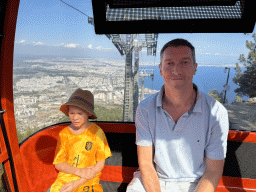 Tim and Max at the Tünektepe Teleferik Tesisleri cable car, with a view on the west side of the city, the city center and the Gulf of Antalya