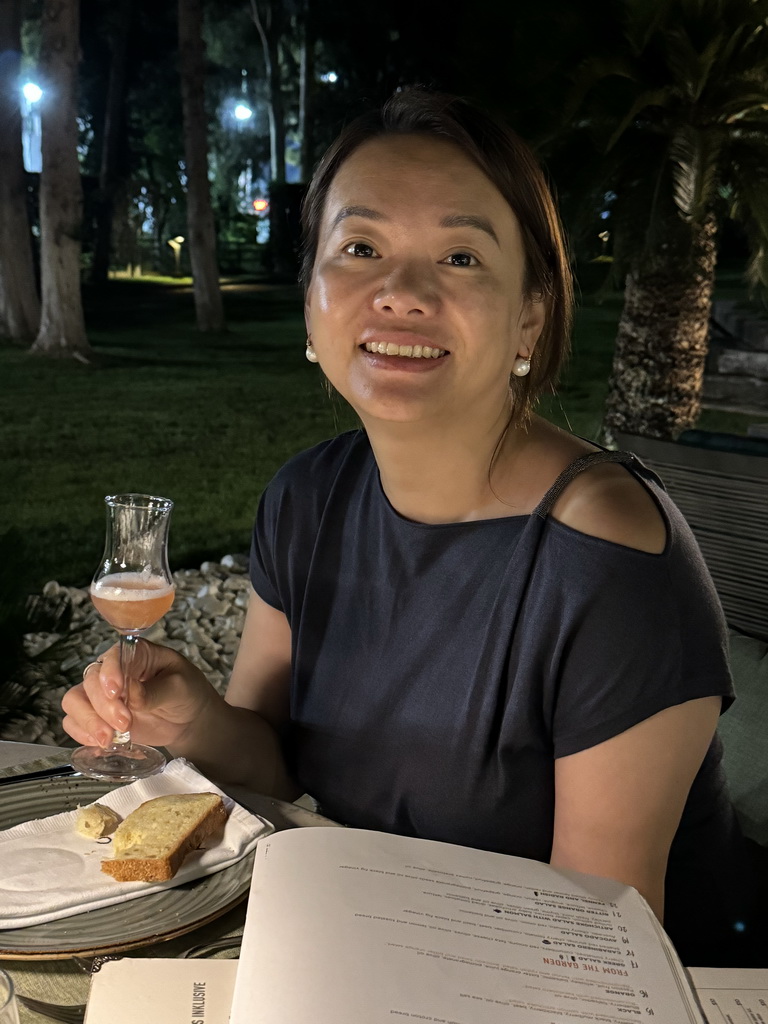 Miaomiao with a cocktail at the terrace of the Turunc restaurant at the garden of the Rixos Downtown Antalya hotel, by night