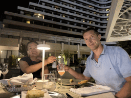 Tim and Miaomiao with a raki and a cocktail at the terrace of the Turunc restaurant at the garden of the Rixos Downtown Antalya hotel, by night