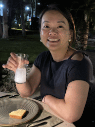 Miaomiao with a raki at the terrace of the Turunc restaurant at the garden of the Rixos Downtown Antalya hotel, by night
