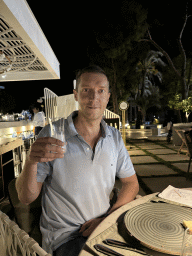Tim with a raki at the terrace of the Turunc restaurant at the garden of the Rixos Downtown Antalya hotel, by night