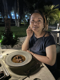Miaomiao with Moroccan lamb tagine with dried plum at the terrace of the Turunc restaurant at the garden of the Rixos Downtown Antalya hotel, by night