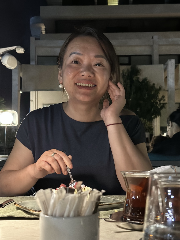 Miaomiao with a Turkish tea at the terrace of the Turunc restaurant at the garden of the Rixos Downtown Antalya hotel, by night