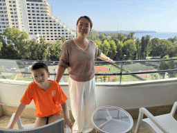 Miaomiao and Max at the balcony of our room at the Rixos Downtown Antalya hotel, with a view on the Sports fields, the Özkaymak Falez Hotel, the city center and the Gulf of Antalya
