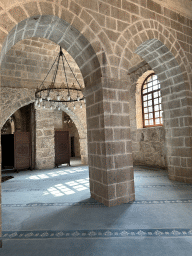 Arches, chandeleer and window at the Sehzade Korkut Mosque