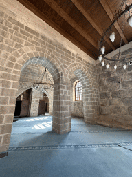 Arches, chandeleers and window at the Sehzade Korkut Mosque