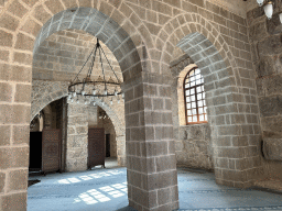 Arches, chandeleer and window at the Sehzade Korkut Mosque