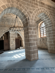 Arches, chandeleer and window at the Sehzade Korkut Mosque