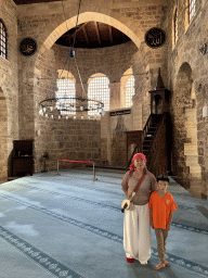 Miaomiao and Max with the pulpit, chandeleer, windows, mihrab and minbar at the Sehzade Korkut Mosque