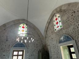 Stained glass windows and chandeleer at the Tekeli Mehmet Pasa Mosque