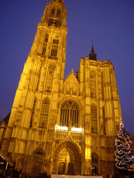 Facade of the Cathedral of Our Lady and a christmas tree at the Handschoenmarkt square, by night