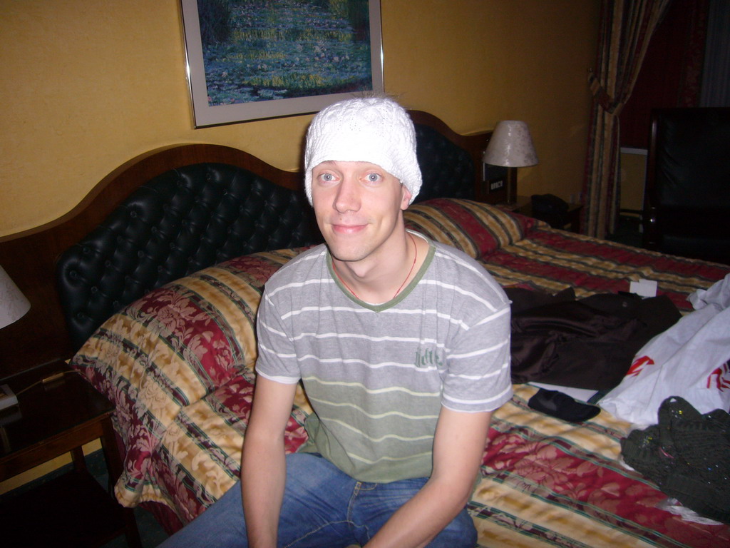 Tim on the bed in our room at a hotel in the city center