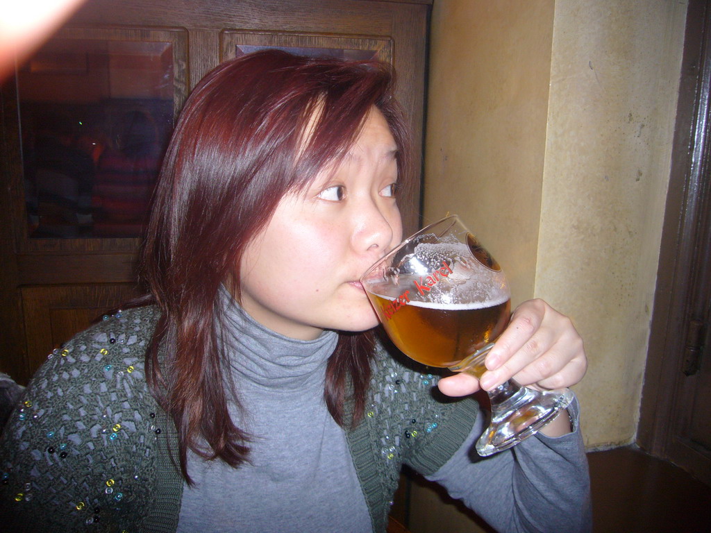 Miaomiao with a Charles Quint beer at the De Valk restaurant