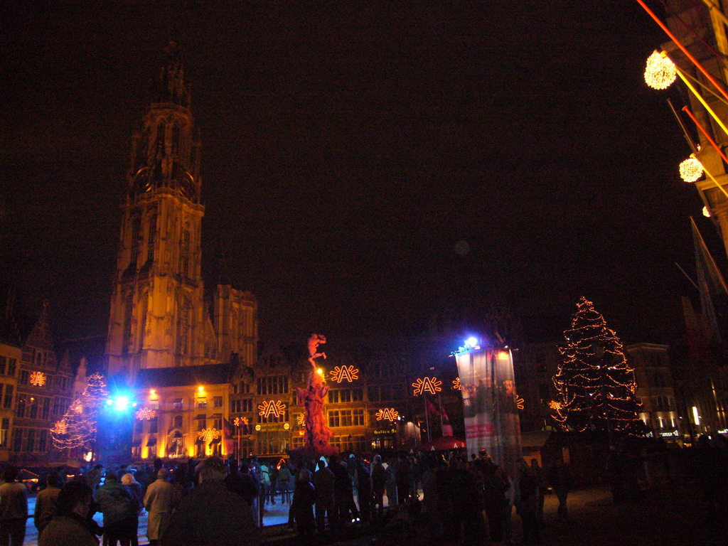 The Grote Markt square with the Brabo Fountain, an ice rink, christmas trees and the Cathedral of Our Lady, by night