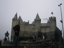 Tim with the Lange Wapper statue and the Het Steen castle at the Steenplein square