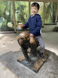 Max on a Chimpanzee statue in front of the Primate Building at the Antwerp Zoo
