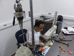 Man working on a diamond ring in the workshop of the Gela diamond shop at the Pelikaanstraat street