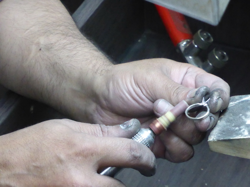 Man working on a diamond ring in the workshop of the Gela diamond shop at the Pelikaanstraat street