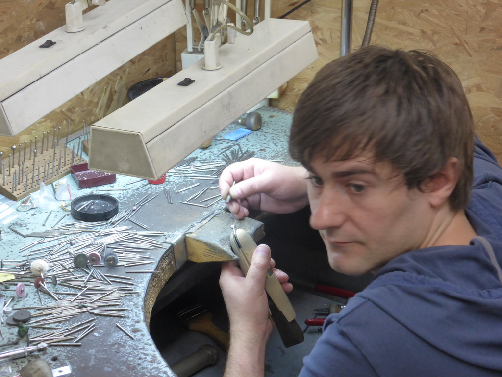 Man working on a diamond ring in the workshop of the Gela diamond shop at the Pelikaanstraat street