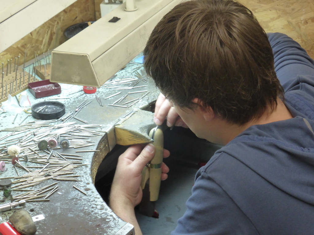 Man working on a diamond ring in the workshop of the Gela diamond shop at the Pelikaanstraat street