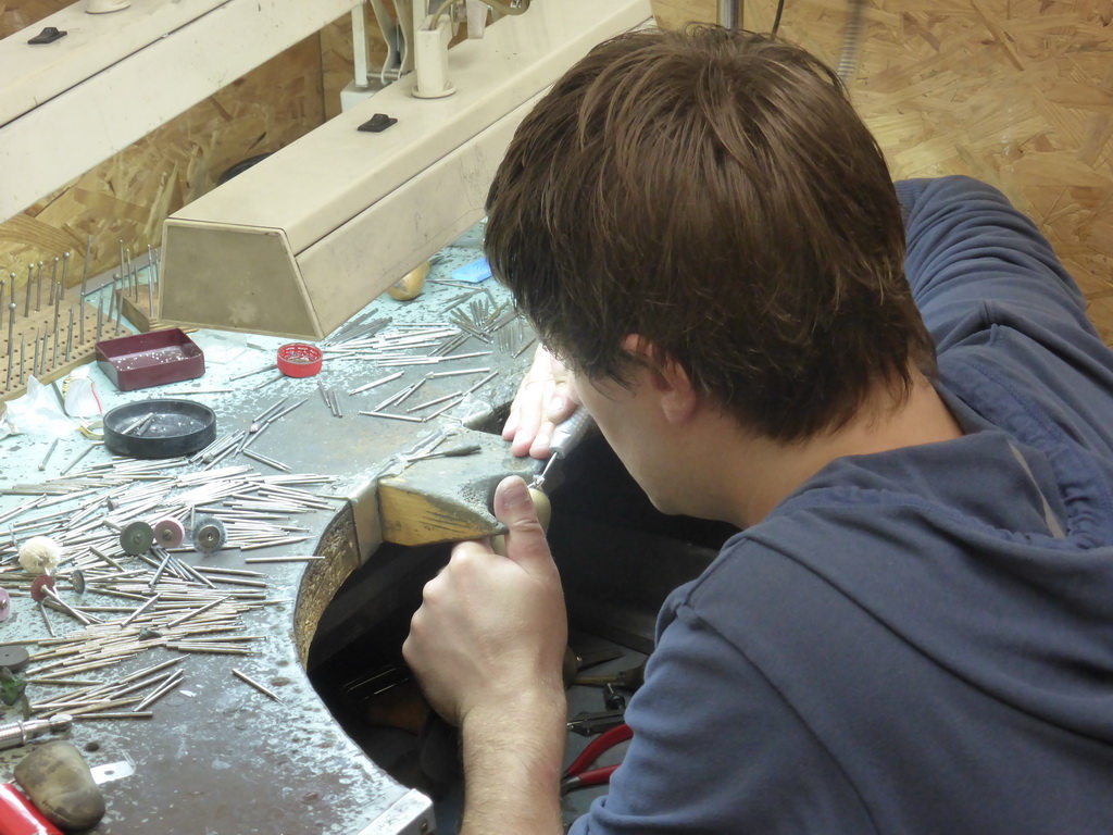 Man working on a diamond ring in the workshop of the Gela diamond shop at the Pelikaanstraat street