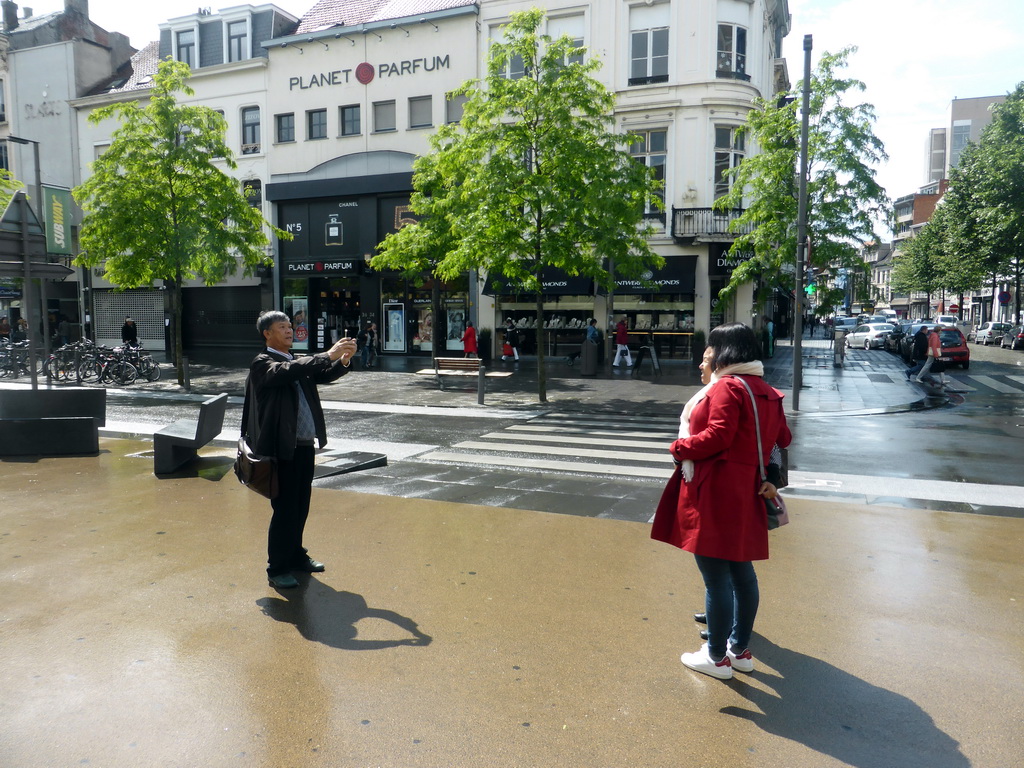 Miaomiao and her parents taking a picture at the Keyserlei street