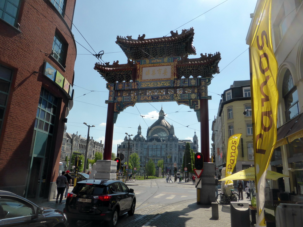 Chinatown Gate at the south side of the Van Wesenbekestraat street, and the front of the Antwerp Central Railway Station at the Koningin Astridplein square