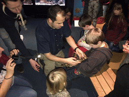 Zookeeper and kids with a snake at the Aqualabo at the Aquatopia aquarium